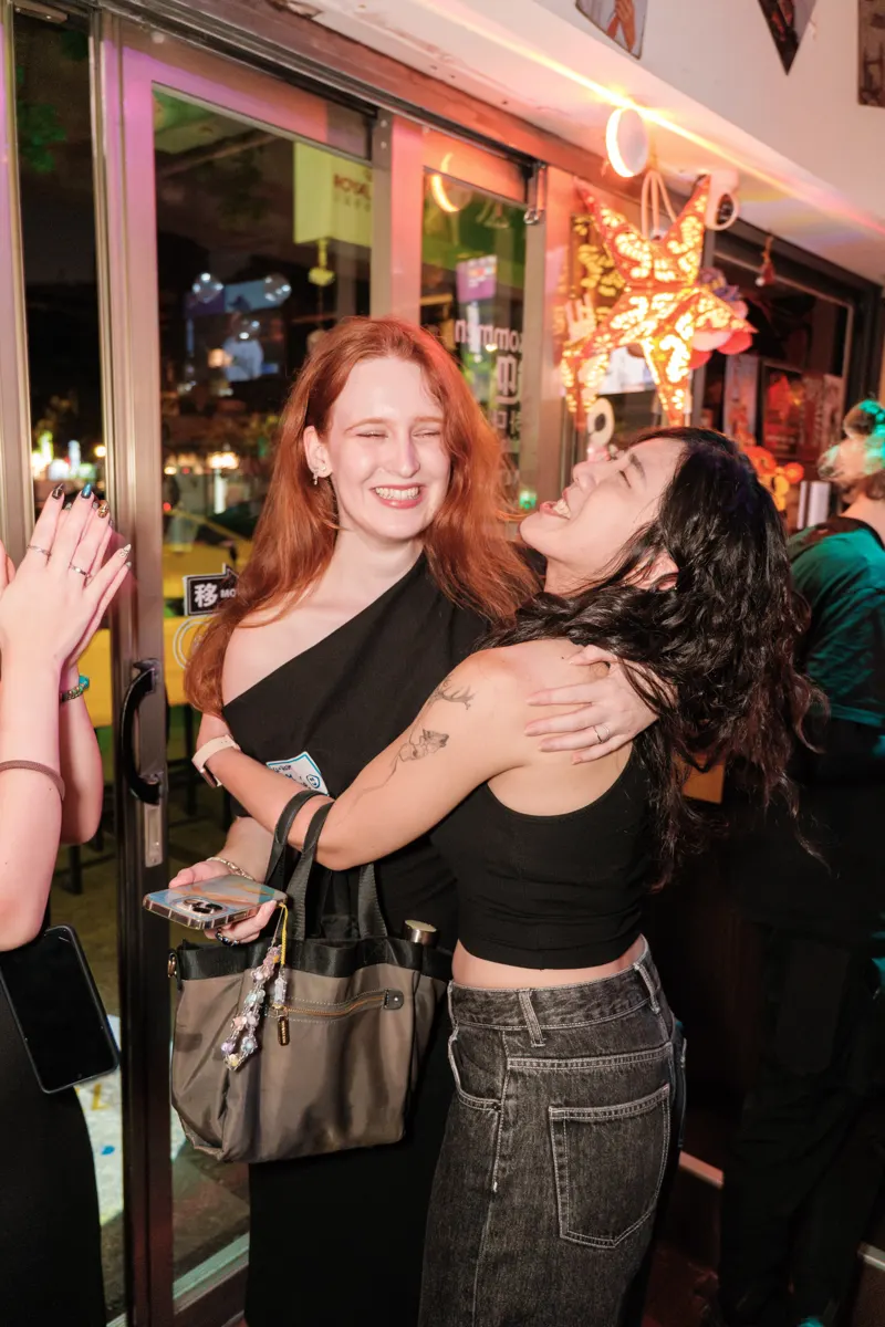 Two guests sharing a laugh at a social event