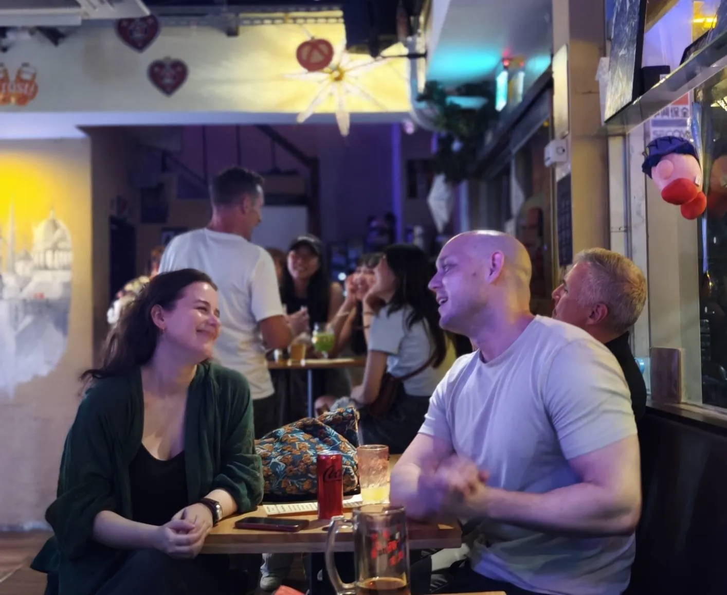 Guests talking over drinks at a bar table