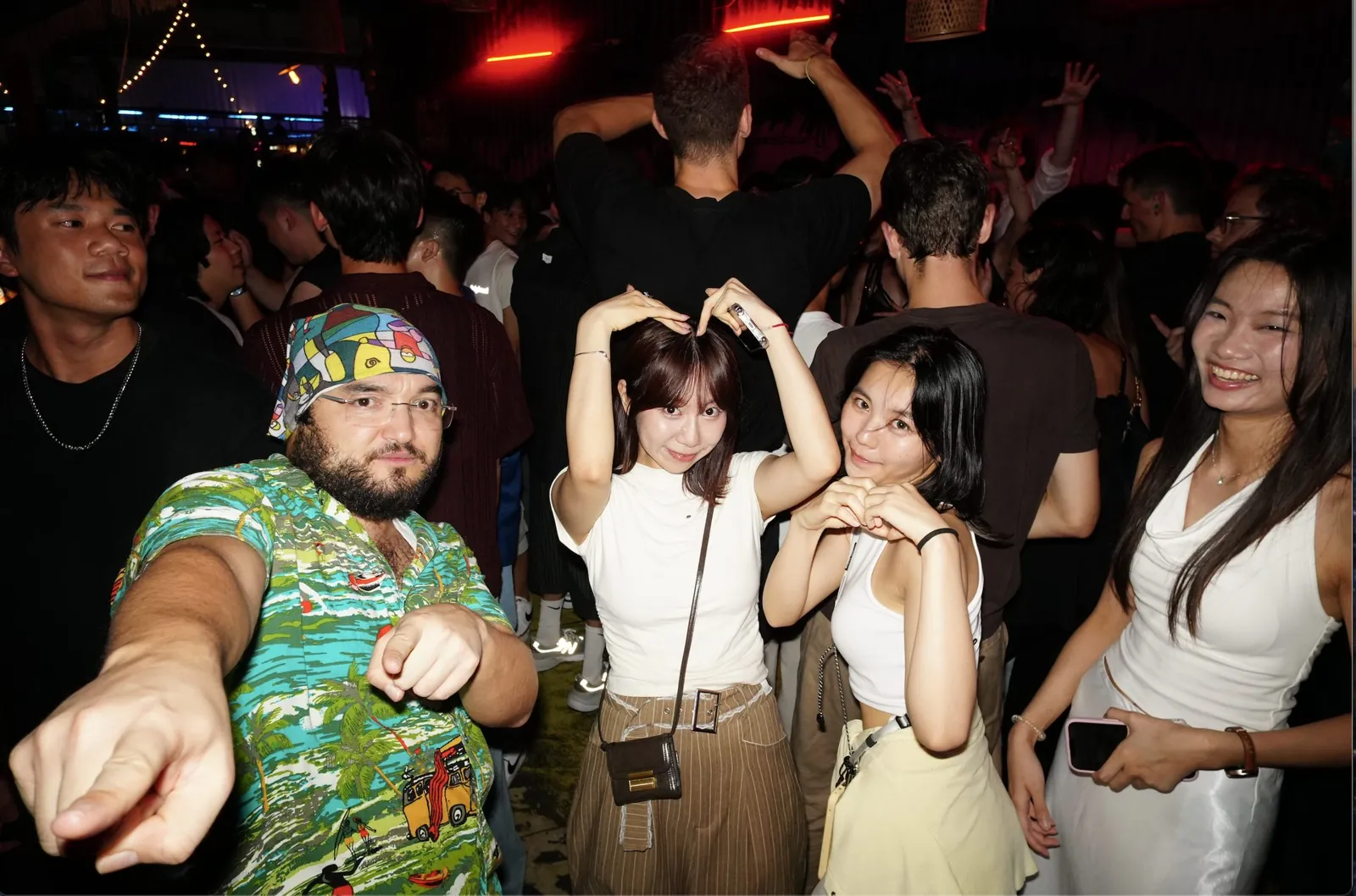 Guests posing together in a busy bar