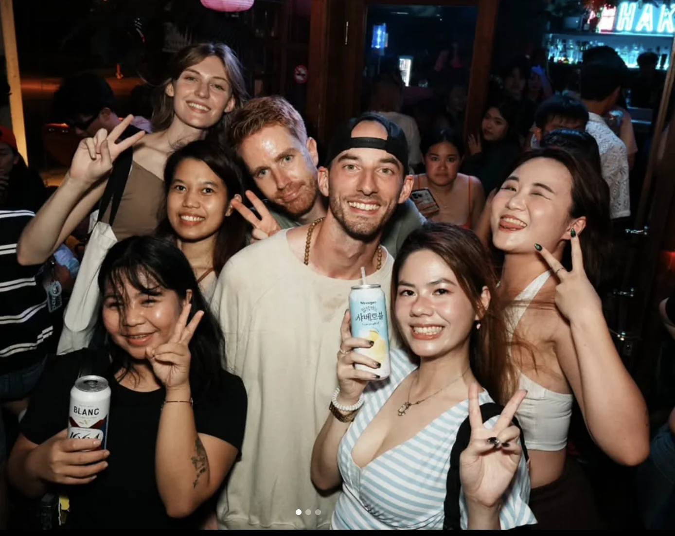 Guests smiling and posing together at a Taipei Singles Night bar gathering